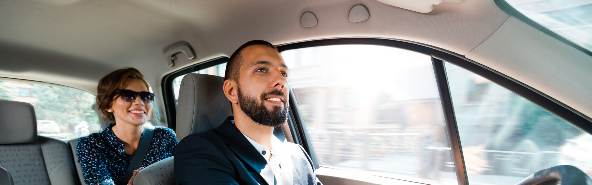 driver and passenger smiling