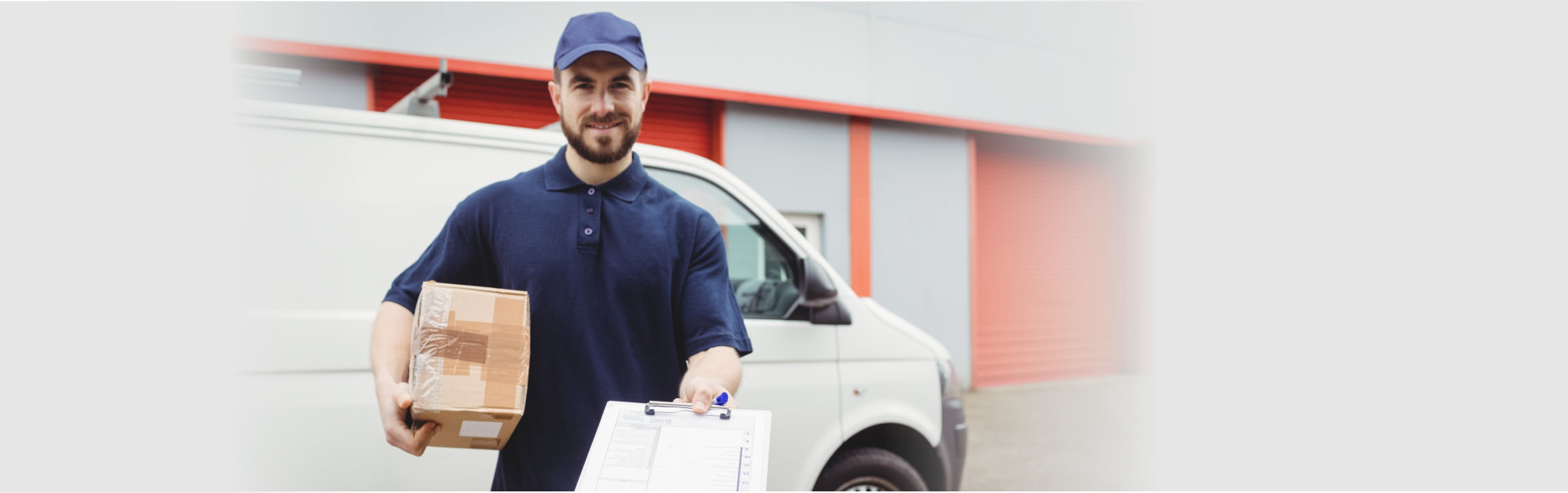 Delivery man holding clipboard and package